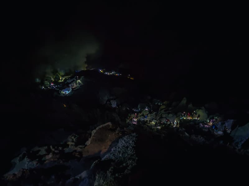 Flashlights on the trail down the crater