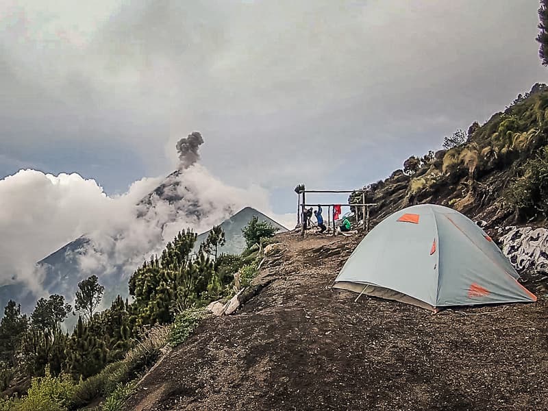 Setting up tents whilst Volcan Fuego erupts in the background